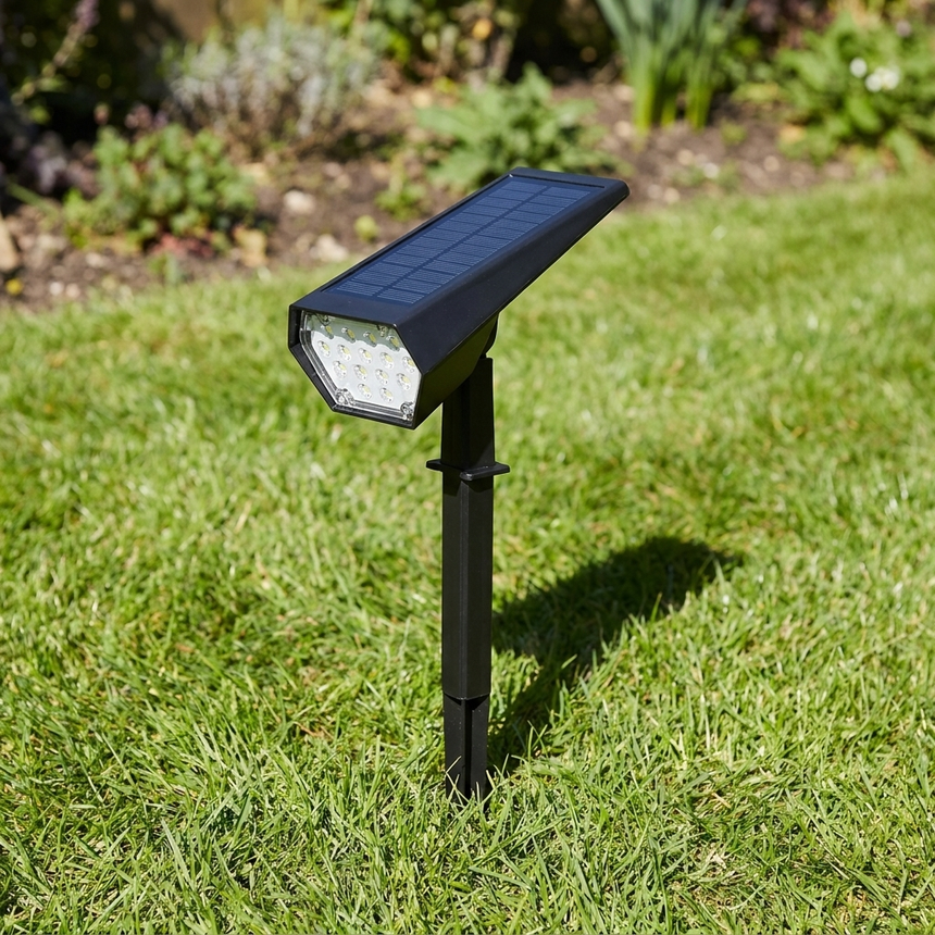 Solar spike light in grass with panel tilted to the sun, daytime